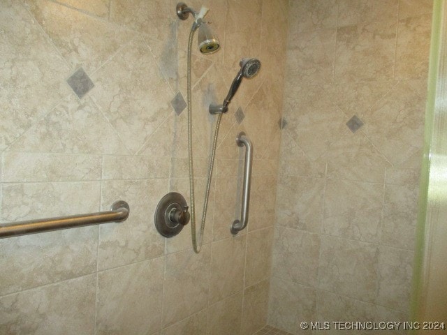 interior details featuring a tile shower