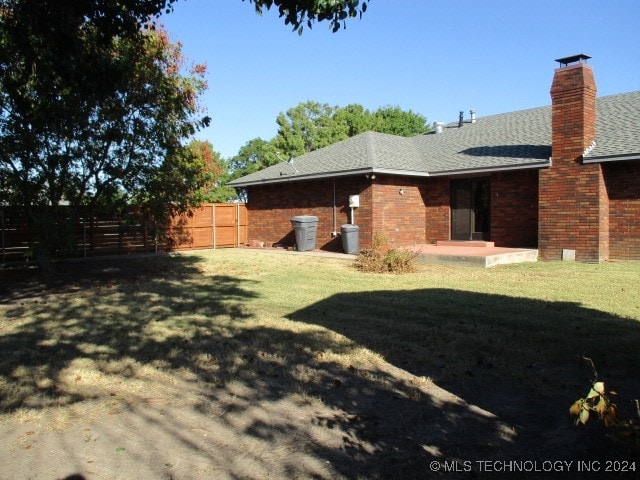 view of yard featuring fence and a patio