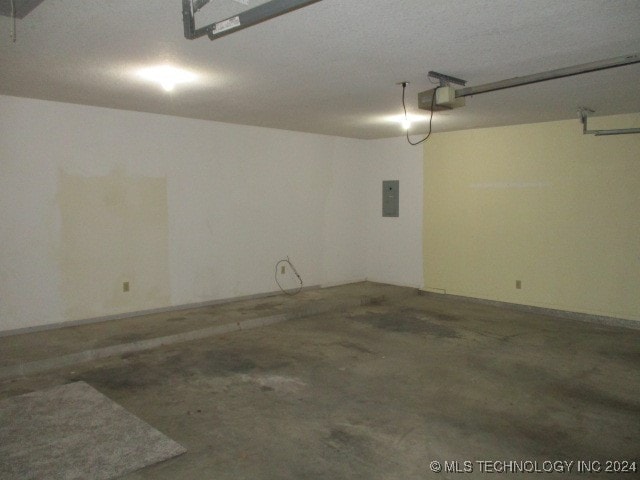 garage featuring a garage door opener and electric panel