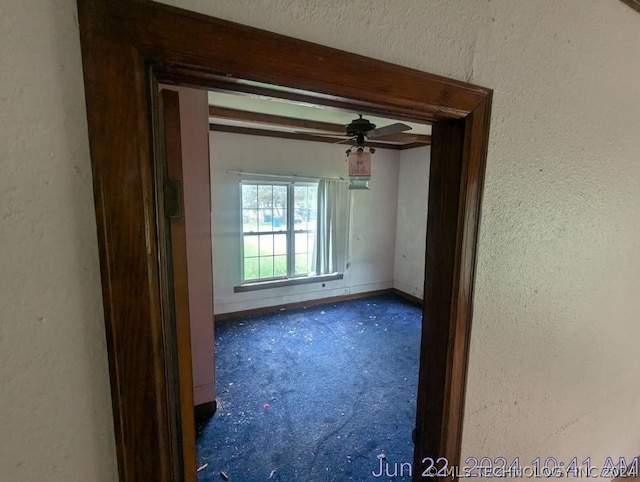 empty room featuring ceiling fan and carpet flooring