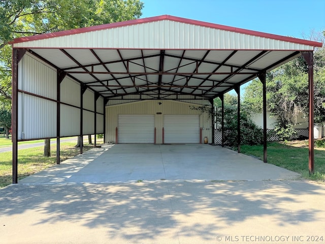 view of vehicle parking featuring a garage and a carport