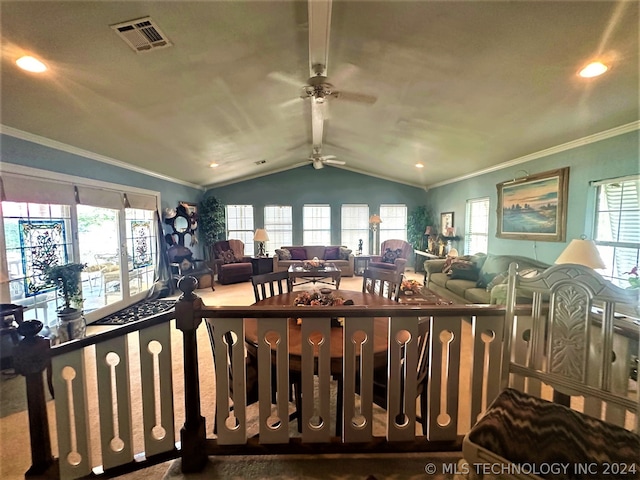 interior space featuring lofted ceiling, ceiling fan, crown molding, and a healthy amount of sunlight