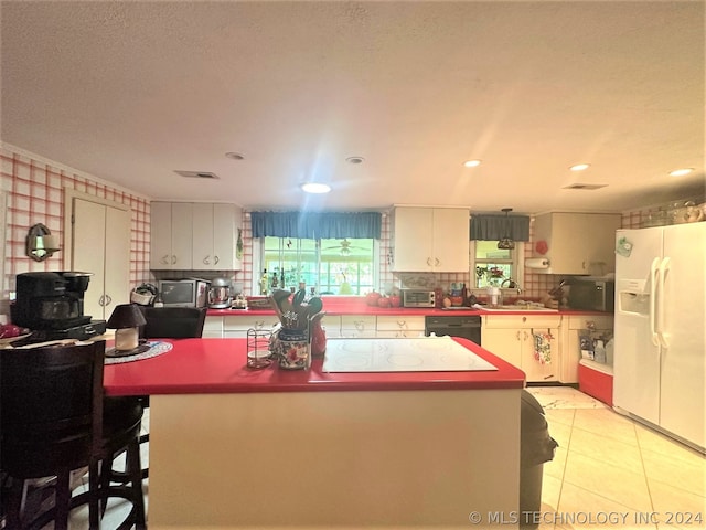 kitchen featuring white cabinetry, black appliances, light tile patterned floors, and tasteful backsplash