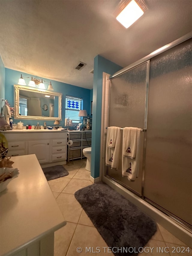 bathroom with walk in shower, tile patterned floors, toilet, and vanity