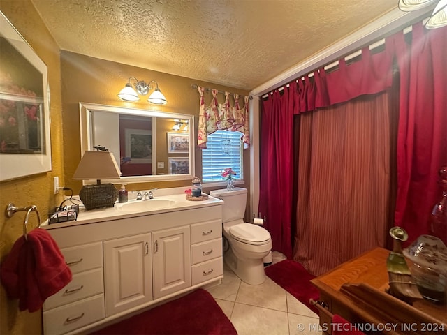 bathroom with vanity, tile patterned floors, a textured ceiling, and toilet