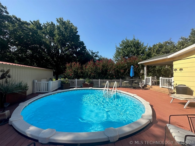 view of swimming pool with a wooden deck