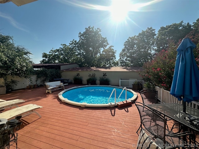 view of pool with a wooden deck