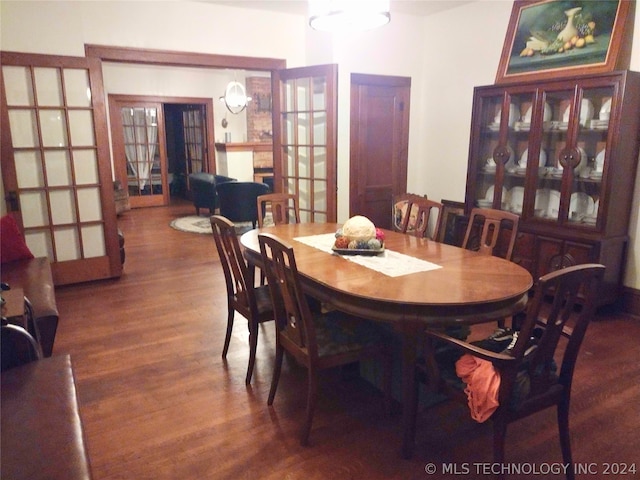 dining area featuring french doors and dark wood-type flooring