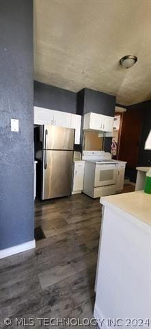 kitchen featuring electric stove, white cabinetry, stainless steel fridge, and dark wood-type flooring