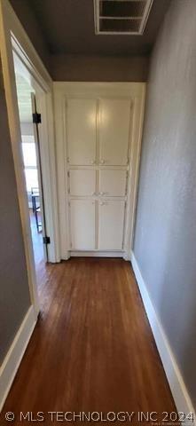 corridor featuring dark wood-type flooring