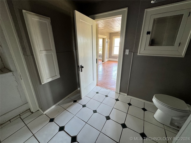 bathroom with a textured ceiling and toilet