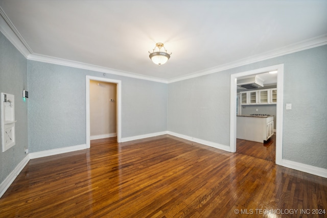 unfurnished room featuring dark wood-type flooring and ornamental molding