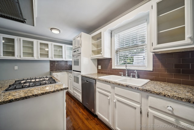 kitchen with white cabinets, sink, appliances with stainless steel finishes, dark hardwood / wood-style flooring, and decorative backsplash