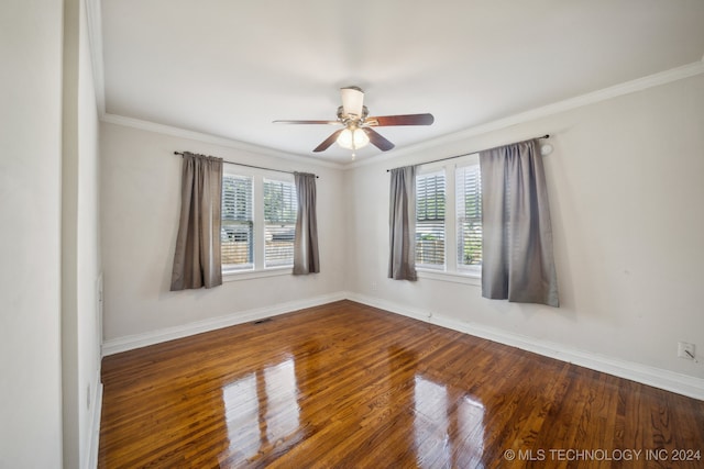 spare room with ceiling fan, crown molding, dark wood-type flooring, and a healthy amount of sunlight