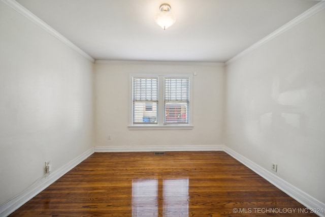 empty room featuring dark hardwood / wood-style floors and ornamental molding