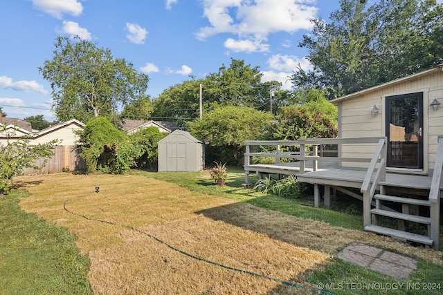 view of yard with a shed and a deck