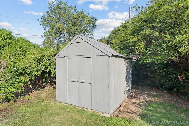 view of outbuilding featuring a lawn