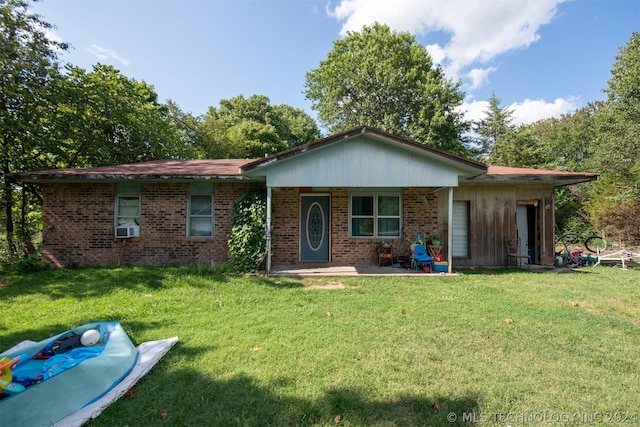 single story home with cooling unit, a front lawn, and a patio