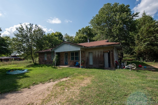 rear view of property with a lawn