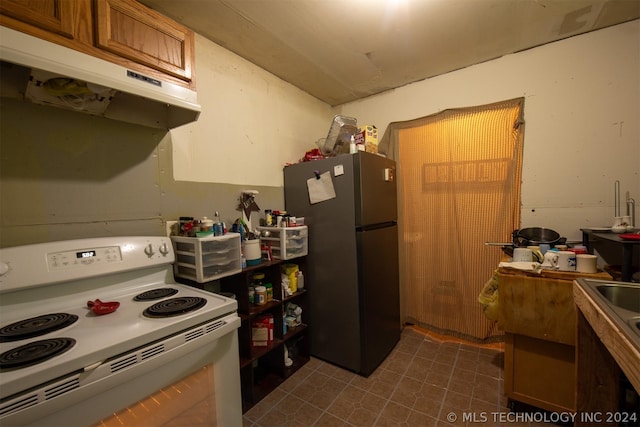 kitchen with fridge and white electric stove