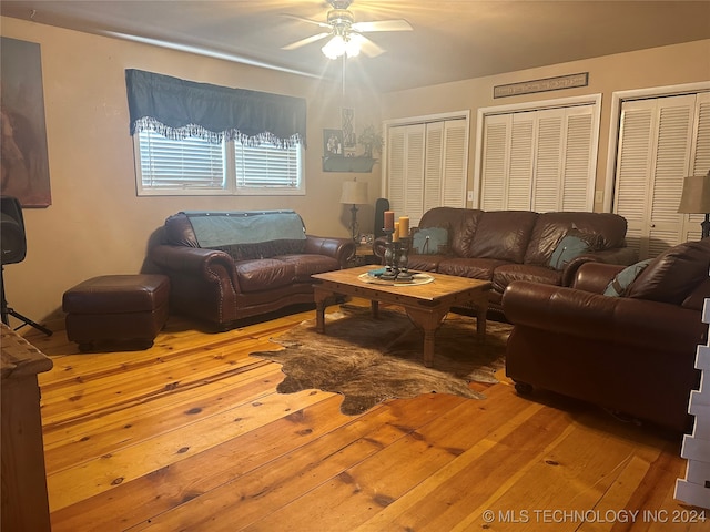 living room featuring ceiling fan and hardwood / wood-style floors