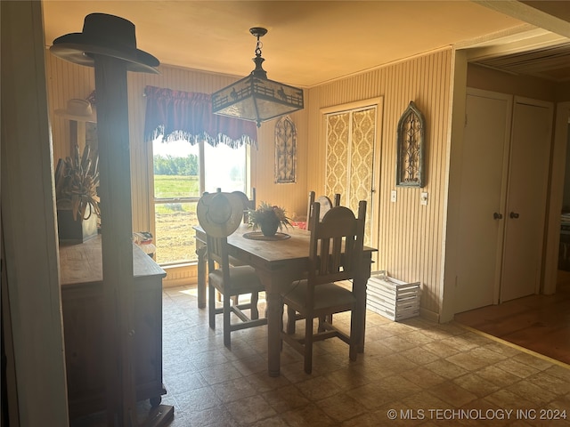 dining area with crown molding and wood-type flooring