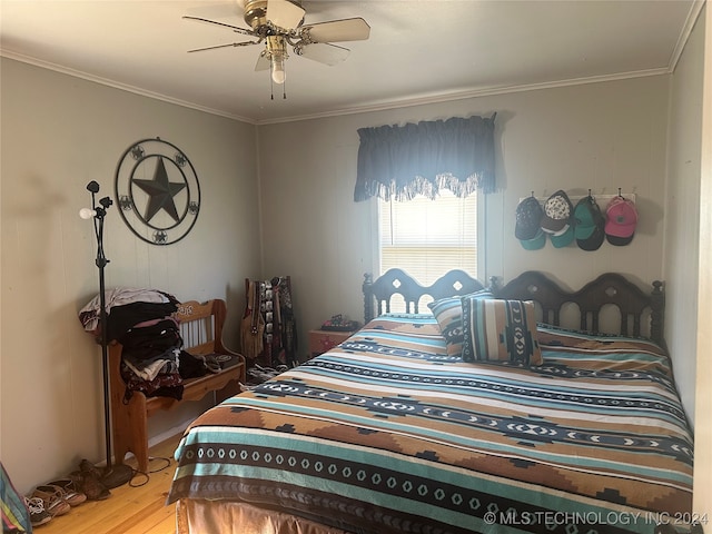 bedroom featuring ceiling fan, ornamental molding, and hardwood / wood-style flooring