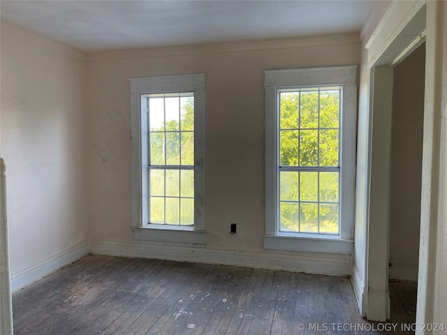 unfurnished room with plenty of natural light and hardwood / wood-style floors