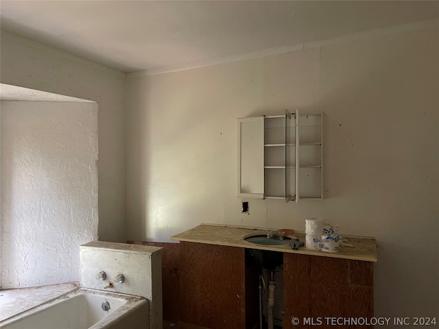 bathroom with vanity and a tub