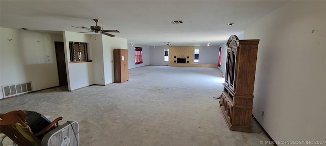 unfurnished room with light colored carpet and ceiling fan