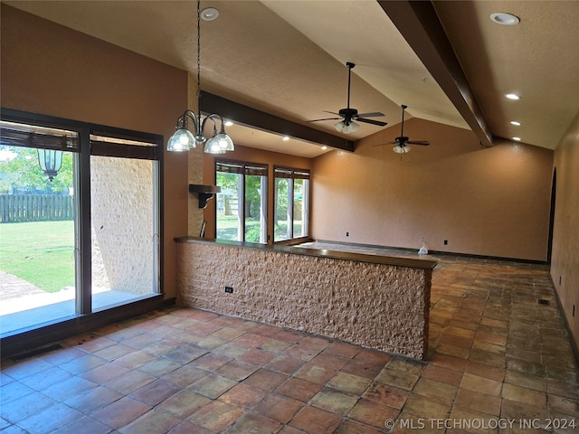 spare room with lofted ceiling with beams, dark tile patterned flooring, and ceiling fan