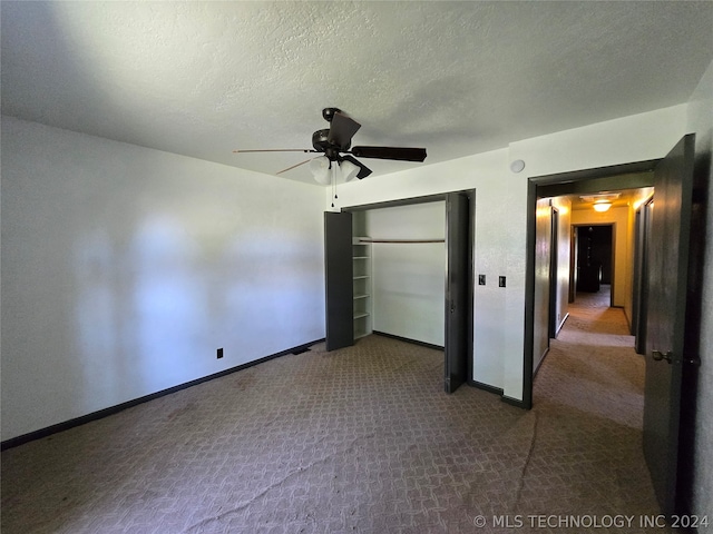 unfurnished bedroom with a textured ceiling, carpet, a closet, and ceiling fan