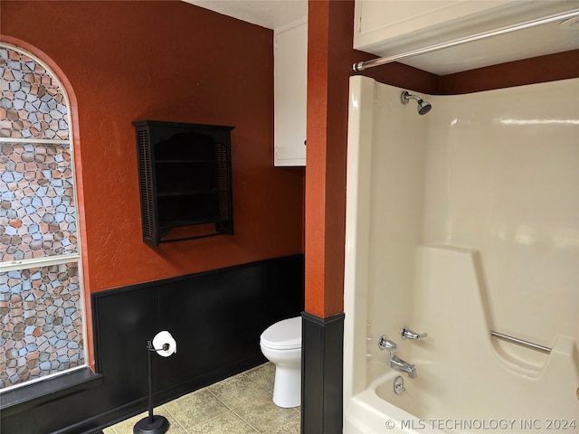 bathroom with shower / bathtub combination, tile patterned floors, and toilet