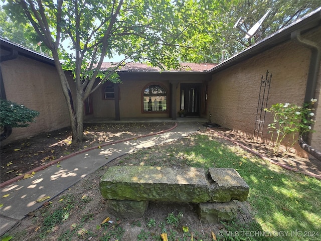 doorway to property featuring stucco siding