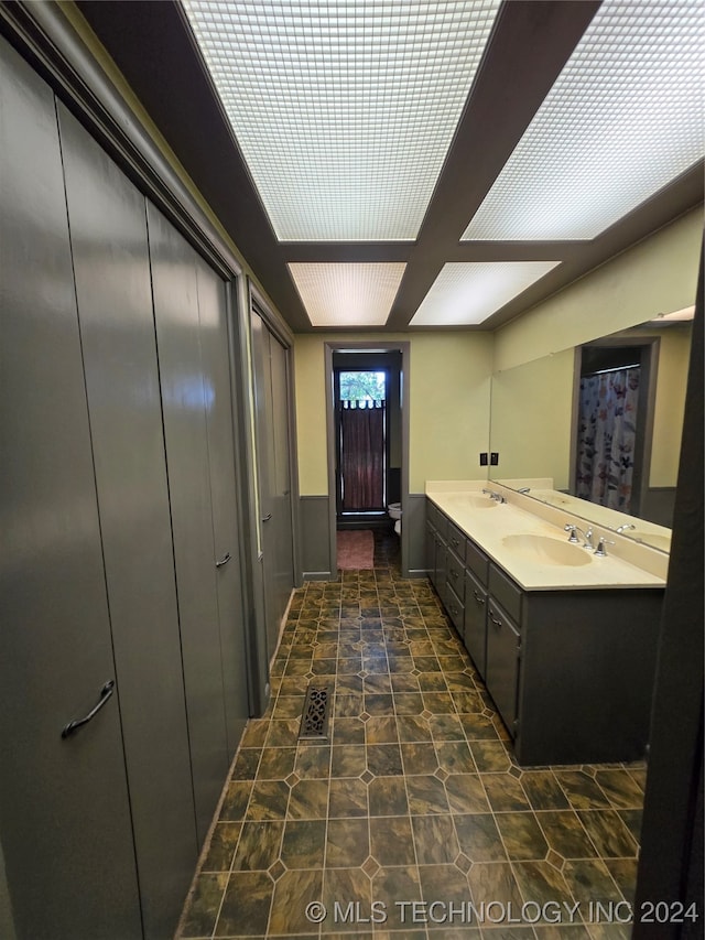 bathroom with tile patterned floors and double sink vanity