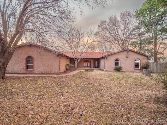 view of front of property with brick siding and a front lawn