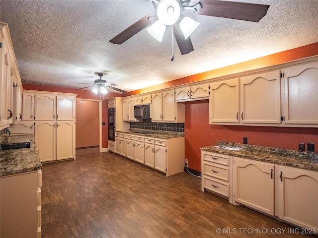 kitchen featuring ceiling fan, black appliances, dark wood-style flooring, and backsplash