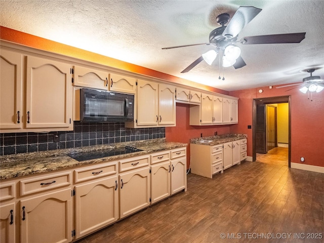 kitchen featuring dark wood-style floors, decorative backsplash, black appliances, a textured ceiling, and baseboards