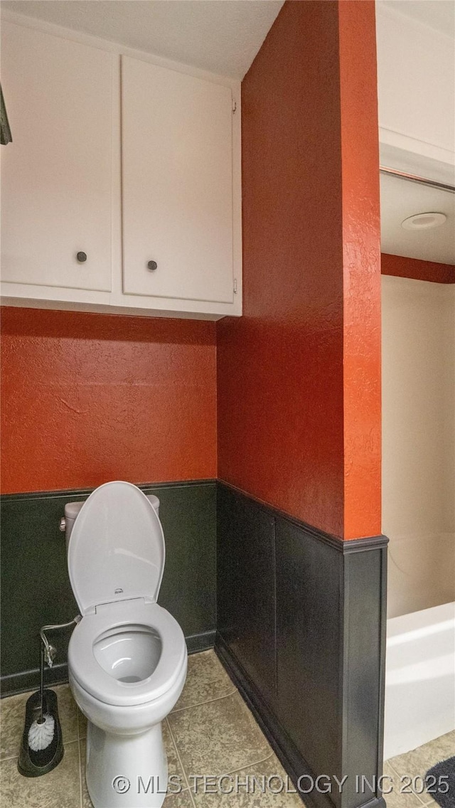 bathroom with tile patterned flooring and toilet