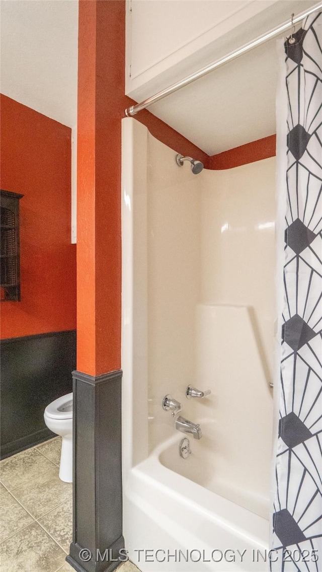 bathroom with toilet and shower / bath combo