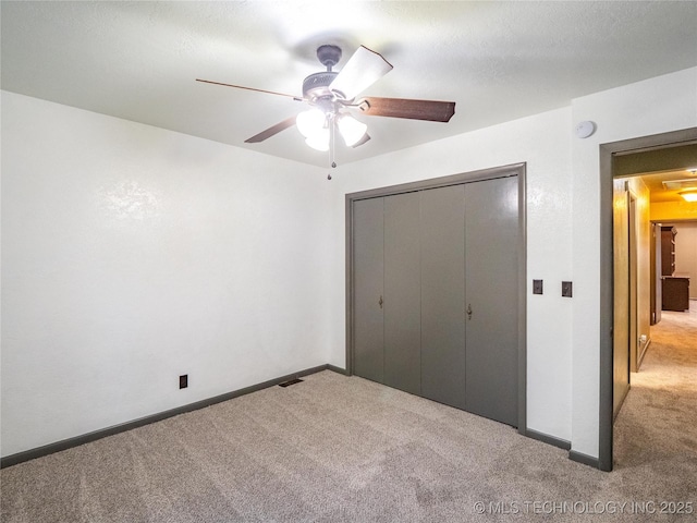 unfurnished bedroom featuring a closet, carpet, and baseboards