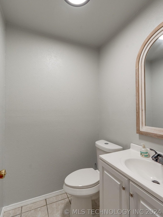 bathroom with tile patterned floors, vanity, and toilet