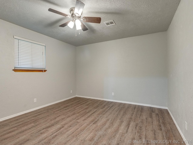 empty room with wood-type flooring, a textured ceiling, and ceiling fan