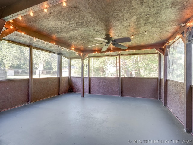 unfurnished sunroom featuring ceiling fan