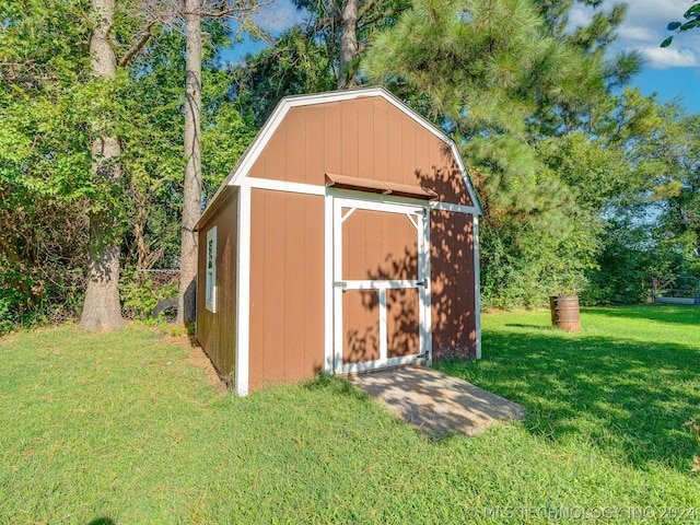 view of outdoor structure featuring a lawn