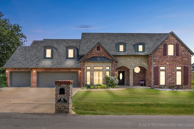 french country inspired facade with a garage and a lawn