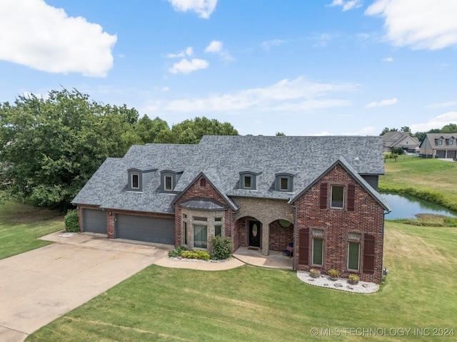 view of front of property featuring a garage and a front yard