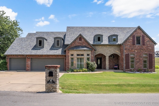 french country home with a garage and a front yard