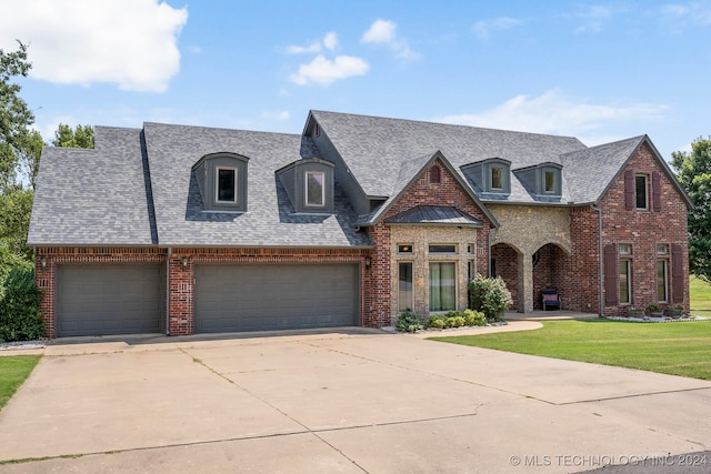 view of front facade with a garage and a front lawn