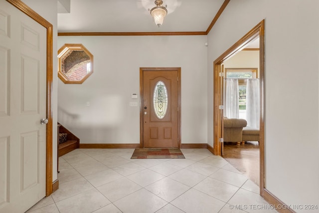 entryway featuring light tile patterned flooring and crown molding